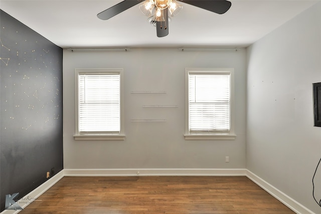 empty room featuring hardwood / wood-style floors, a healthy amount of sunlight, and ceiling fan