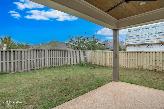 view of yard featuring ceiling fan and a patio