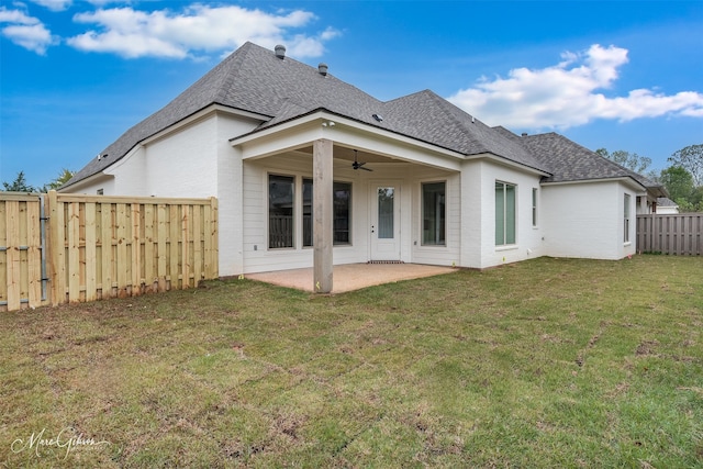 rear view of house with a patio area, a yard, and ceiling fan