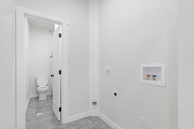 laundry area featuring light tile patterned flooring, washer hookup, and hookup for an electric dryer