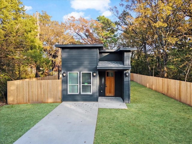 contemporary home featuring a patio area and a front yard