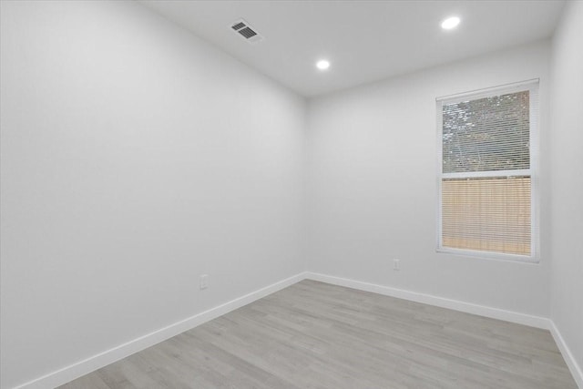 empty room with light hardwood / wood-style flooring