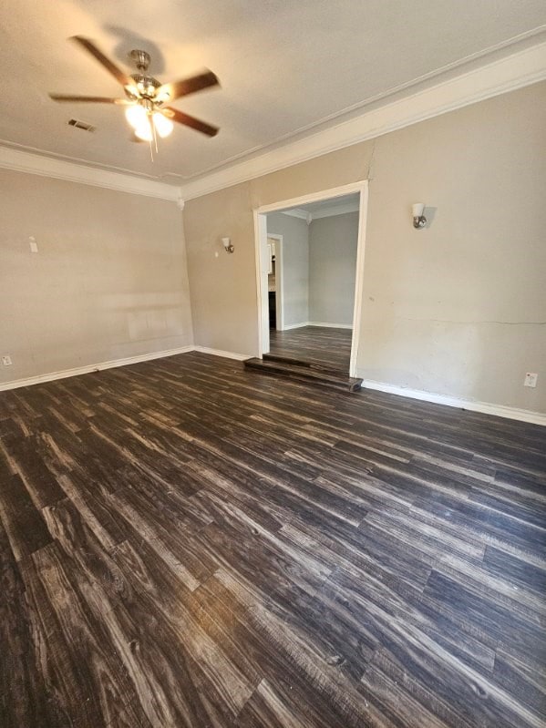 spare room with ceiling fan, dark hardwood / wood-style floors, and ornamental molding