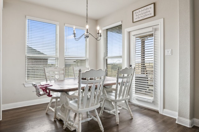 dining area featuring a wealth of natural light, dark hardwood / wood-style floors, and a chandelier