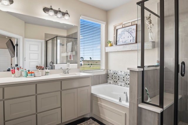 bathroom featuring vanity and separate shower and tub