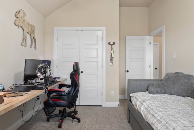 carpeted office space featuring vaulted ceiling