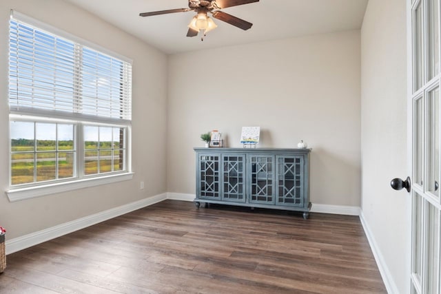 spare room with ceiling fan and dark hardwood / wood-style flooring