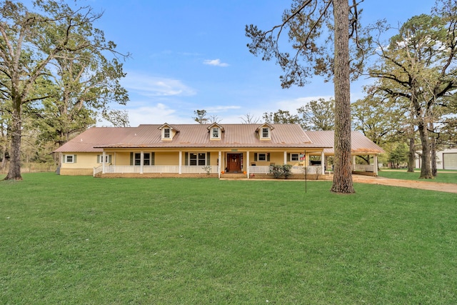 rear view of house featuring a porch and a lawn