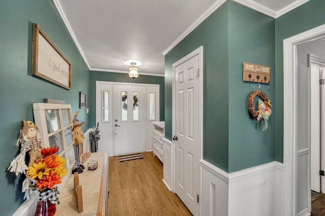 foyer with light hardwood / wood-style flooring and crown molding