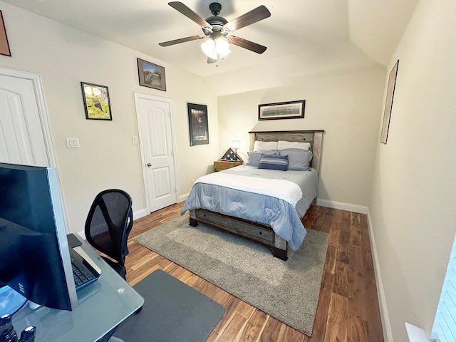 bedroom with hardwood / wood-style floors, vaulted ceiling, and ceiling fan