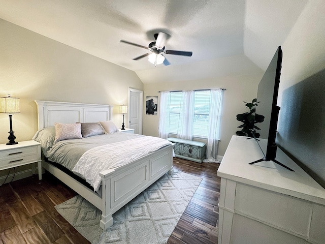 bedroom featuring lofted ceiling, dark hardwood / wood-style floors, and ceiling fan