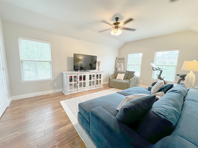 living room featuring ceiling fan, lofted ceiling, and light hardwood / wood-style flooring