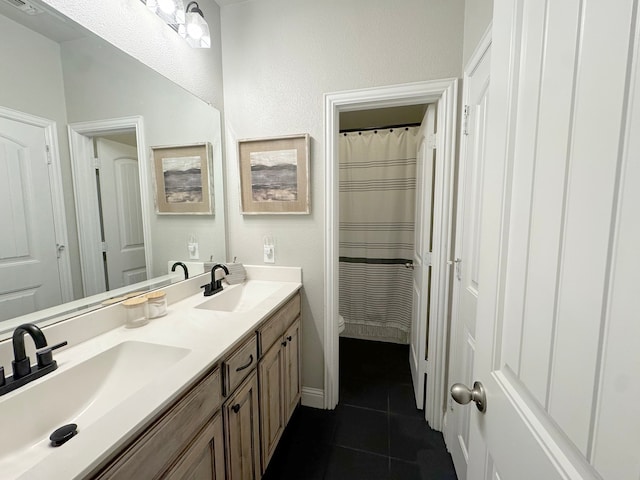 bathroom featuring tile patterned floors, vanity, and a shower with shower curtain