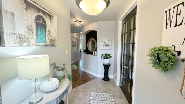 hall featuring light tile patterned flooring