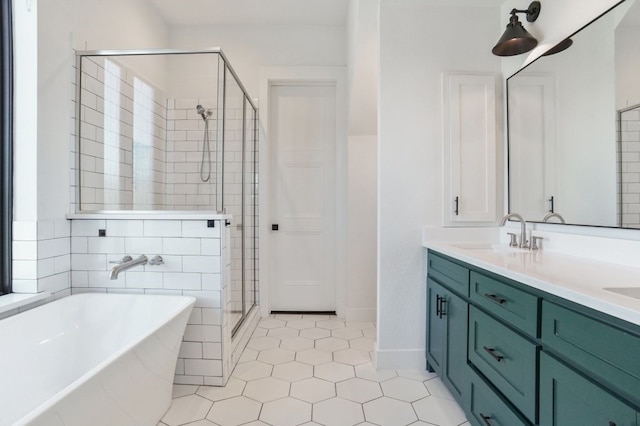 bathroom featuring independent shower and bath, vanity, and tile patterned flooring