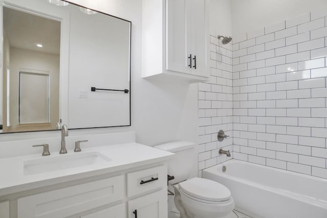 full bathroom with tiled shower / bath, toilet, and vanity