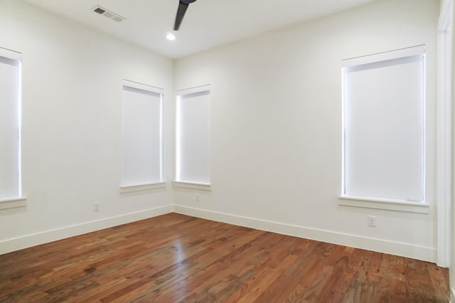 unfurnished room with hardwood / wood-style floors