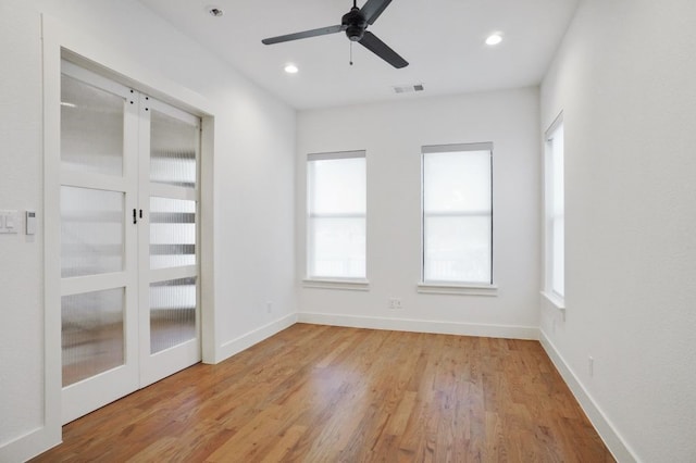 unfurnished room with light wood-type flooring and ceiling fan