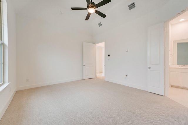 interior space with a ceiling fan, light carpet, visible vents, and baseboards