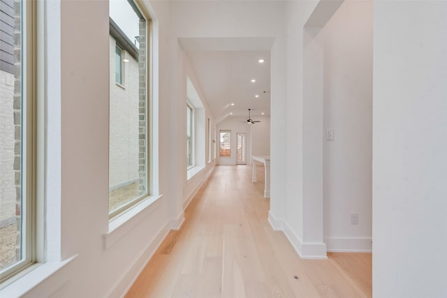 hall with light wood-type flooring, baseboards, and recessed lighting