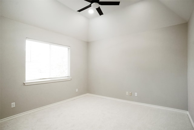 carpeted empty room with ceiling fan and lofted ceiling