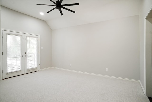 spare room featuring lofted ceiling, ceiling fan, light carpet, and french doors