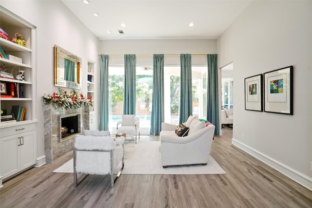 living room with light hardwood / wood-style floors and built in features