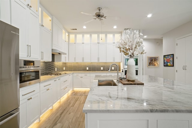 kitchen featuring light hardwood / wood-style flooring, sink, and white cabinets