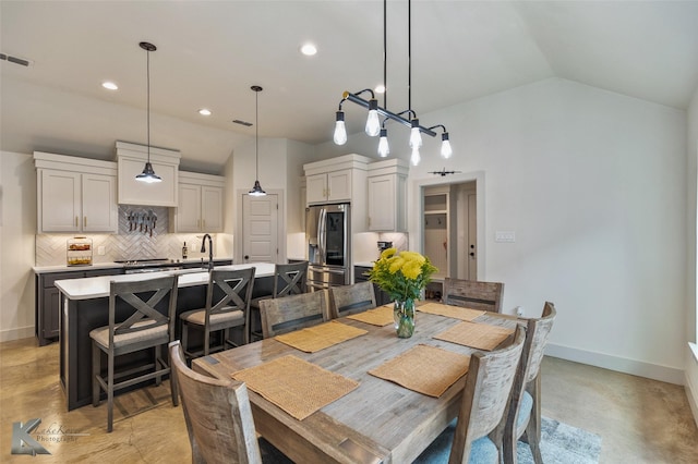 dining room featuring vaulted ceiling