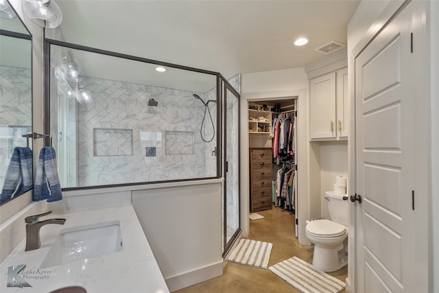 bathroom featuring vanity, toilet, and walk in shower