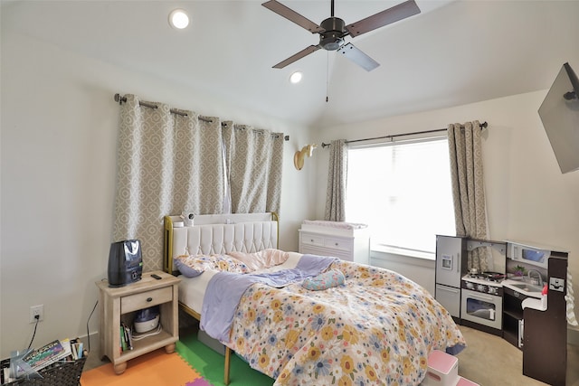 bedroom with lofted ceiling, light colored carpet, and ceiling fan