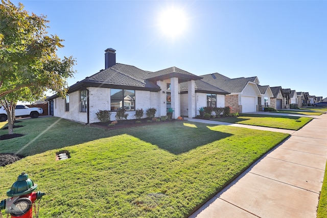 view of front of home featuring a front yard and a garage