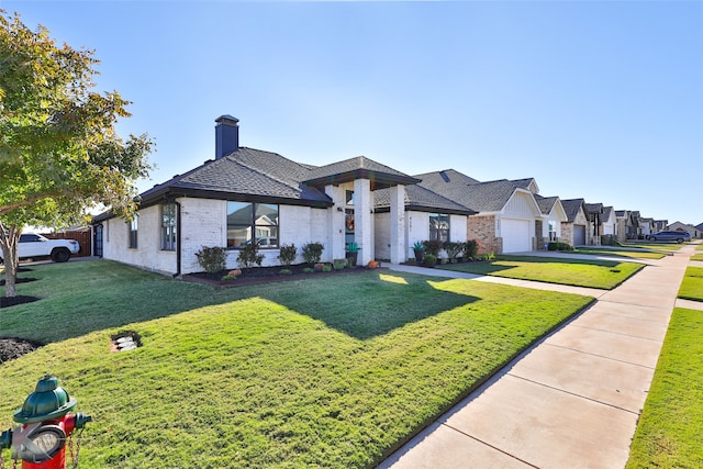 view of front of home featuring a front lawn and a garage