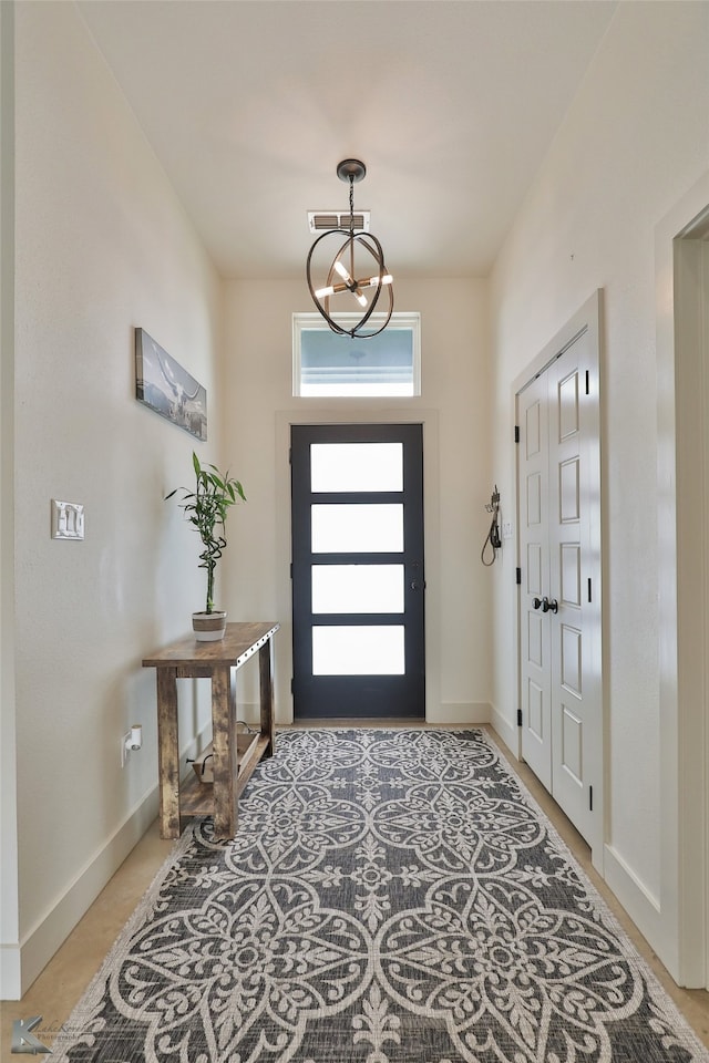 foyer entrance featuring an inviting chandelier