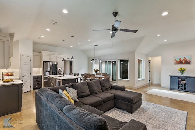 living room with ceiling fan, lofted ceiling, and sink