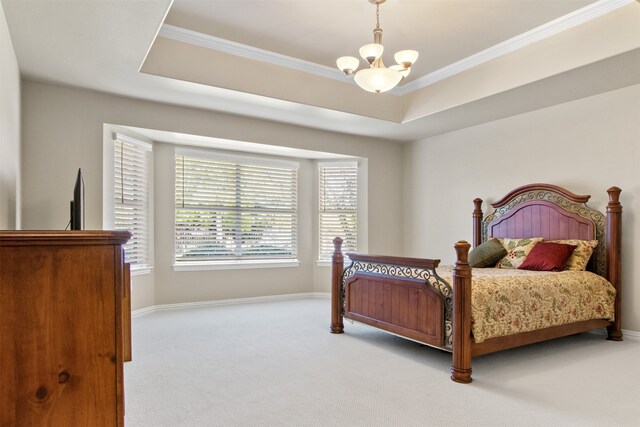 bedroom featuring light colored carpet, a raised ceiling, and crown molding