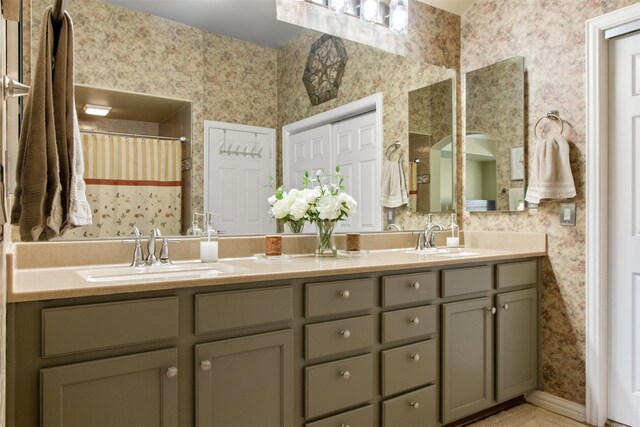 bathroom featuring walk in shower and vanity