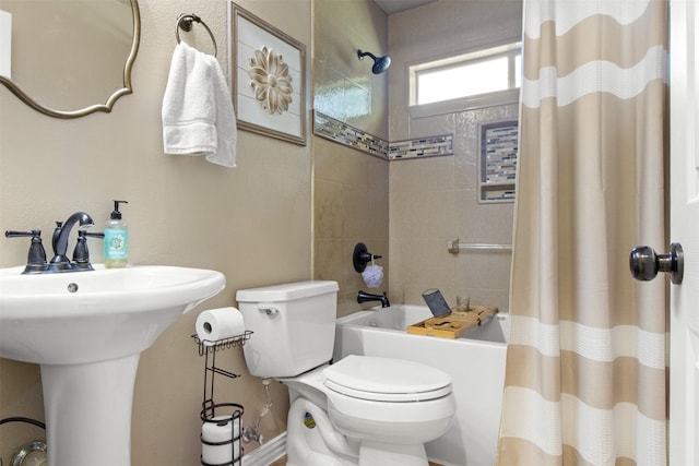 full bathroom featuring toilet, shower / tub combo, and sink