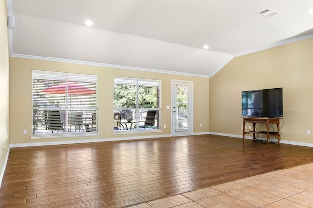 unfurnished living room featuring vaulted ceiling, ornamental molding, and light wood-type flooring