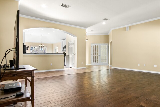 unfurnished living room with vaulted ceiling, light hardwood / wood-style floors, and crown molding