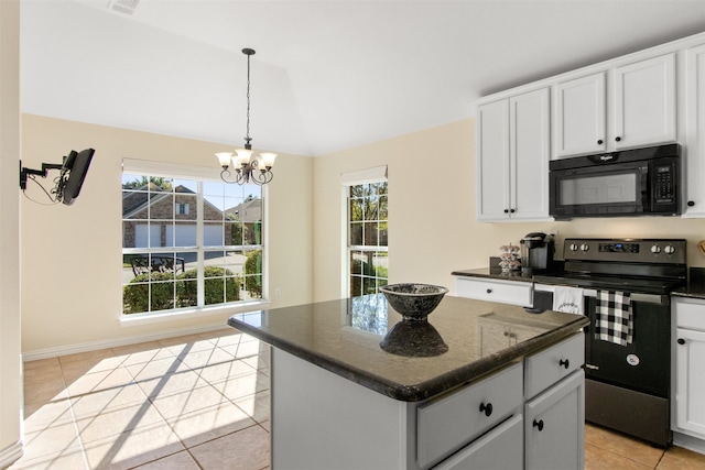 kitchen featuring white cabinets, plenty of natural light, black appliances, and a kitchen island