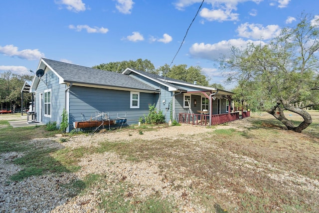 rear view of property with covered porch