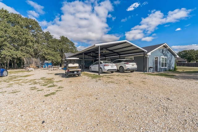 view of parking with a carport and a trampoline