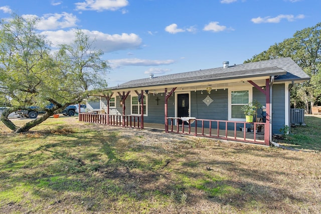 ranch-style home with central AC, covered porch, and a front lawn