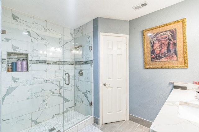 bathroom featuring an enclosed shower, vanity, and tile patterned floors