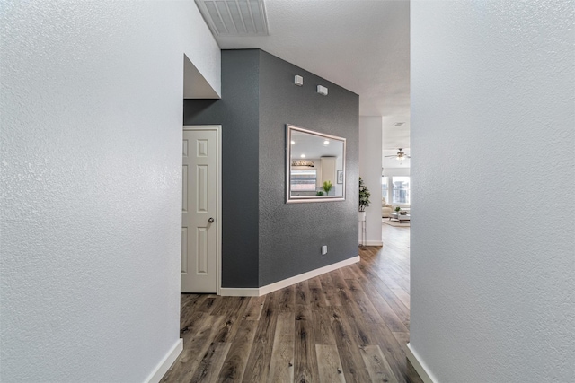 corridor with dark hardwood / wood-style flooring