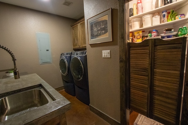 laundry area featuring cabinets, independent washer and dryer, electric panel, and sink