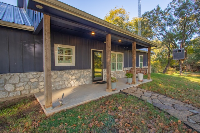 entrance to property with a lawn