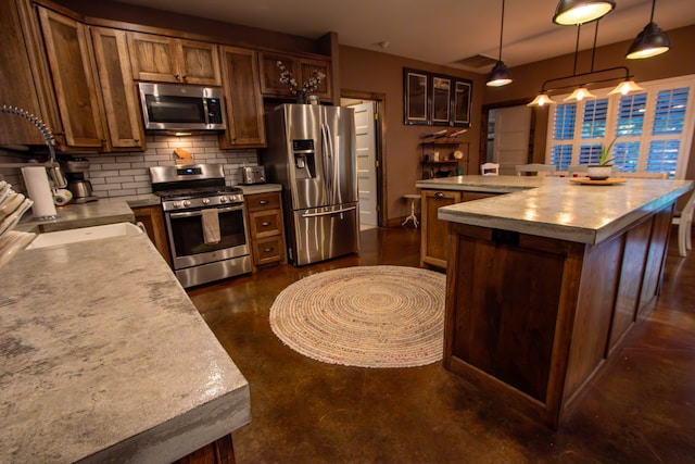 kitchen featuring a center island, sink, stainless steel appliances, backsplash, and pendant lighting