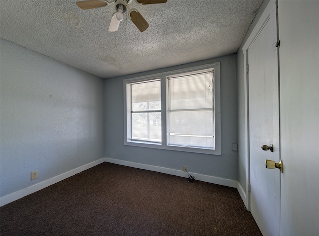 carpeted spare room featuring ceiling fan and a textured ceiling